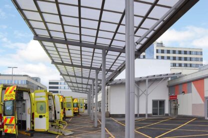 Picture shows a row of ambulances with their back doors open under the canopy