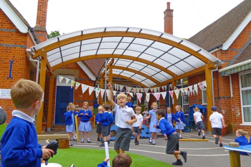 Picture shows children playing in school playground under the new canopy