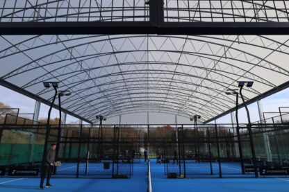 Picture show an aerial shot of the new padel court and it's roofing with a light blue court