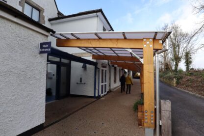 Picture show a new timber frame, cantilever walkway made from Norwegian Spruce at Tetbury Hospital