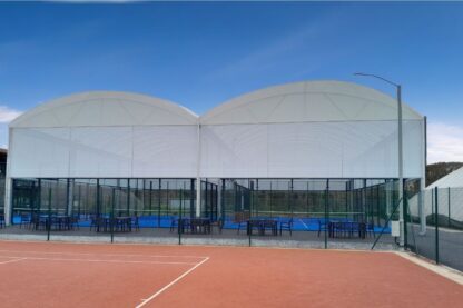 Picture show two covered padel courts from the back