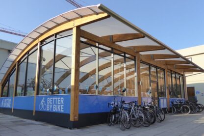 Pictures shows timber canopied bike shelter f provides attractive all-weather protection on campus University of the West of England (UWE Bristol)