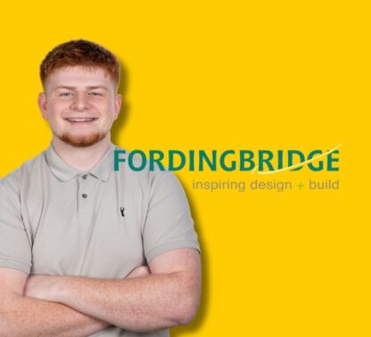 Picture shows Ethan Morris standing with his arms folder with the Fordingbridge logo in the background