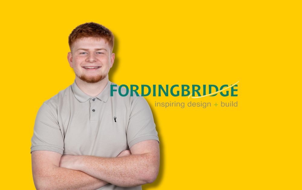 Picture shows Ethan Morris standing with his arms folder with the Fordingbridge logo in the background