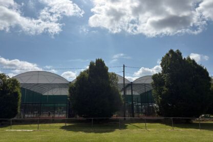 Picture show a glimpse of the new padel court canopy covers through the trees
