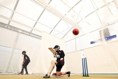 Picture shows new canopy cover at Darwen Cricket Club. In the picture there are two boys playing cricket with a cricket ball in the foreground.