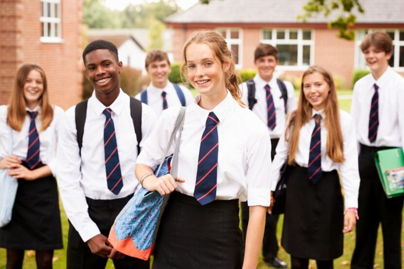 Picture shows a group of school students looking to the camera smiling.