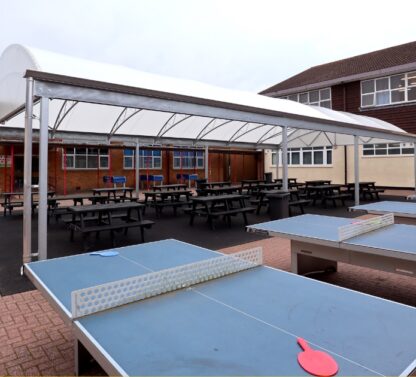 Picture shows new dinning canopy at Five Acers High School. In the foreground there are table tennis tables.