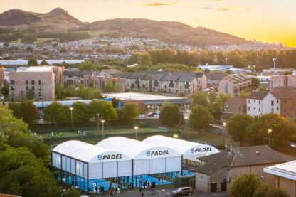 All-weather padel court canopies at Powerleague Portobello with Arthur’s Seat in the background at sunset
