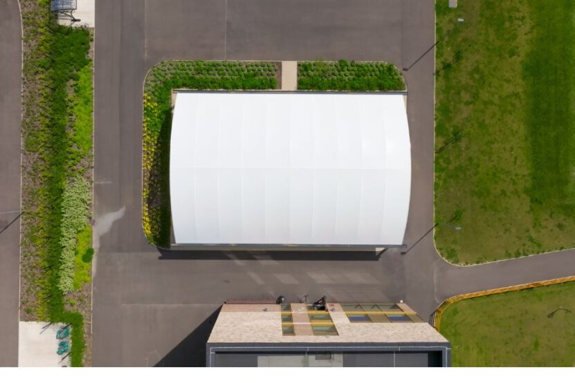 Aerial view of all-weather school dining canopy installed in a new location on a school site