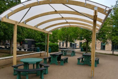 Timber-framed school canopy shelter creating an all-weather outdoor seating and social space for students