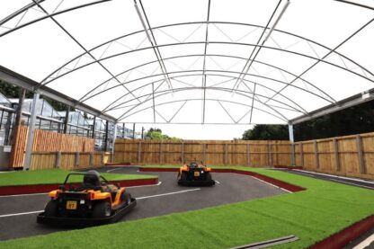 All-weather canopy covering the mini racetrack at Craft Nurseries in Essex, creating a year-round family attraction for visitors.