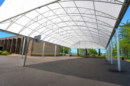 Large MUGA canopy at Saltash Community School creating a bright, all-weather sports area for year-round PE and games.