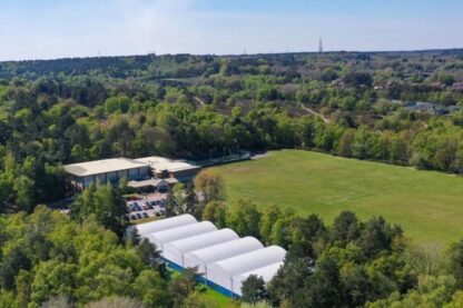Aerial view of Pure Padel’s all-weather covered padel courts surrounded by woodland.
